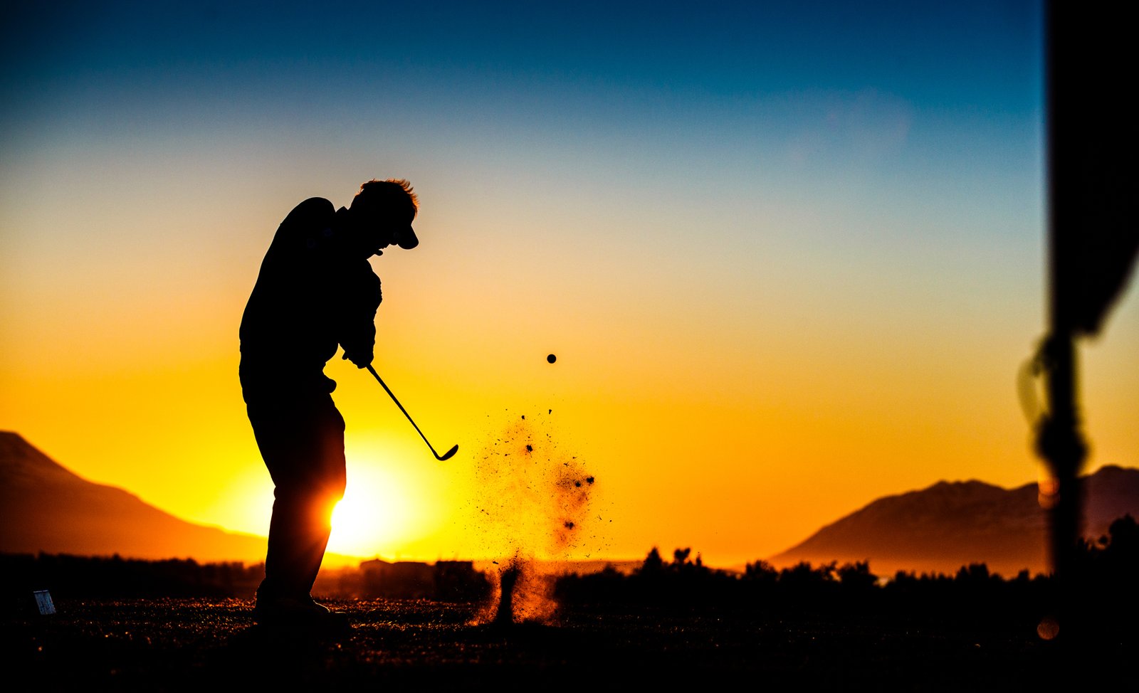 Golfer silhouetted against the midnight sun during the Arctic Open at Ja&eth;arsv&ouml;llur