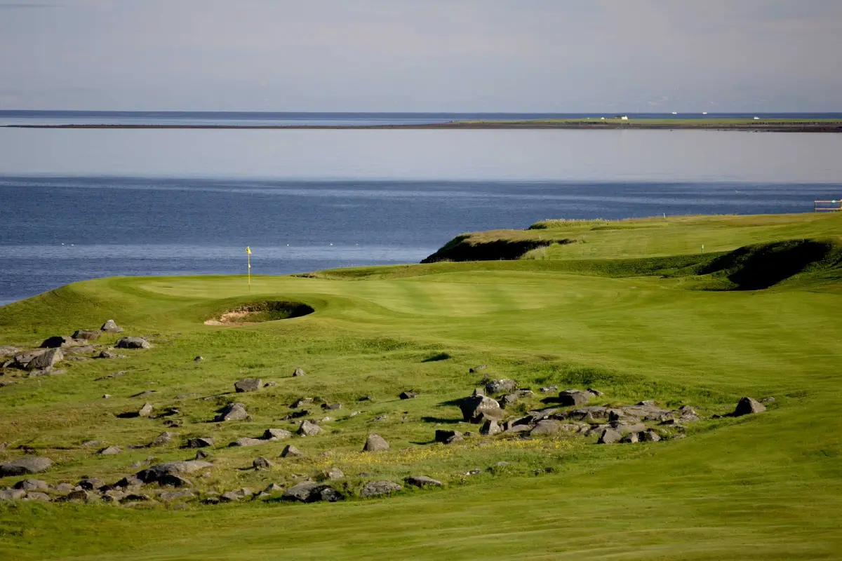 Flag on a green surrounded by lava rock at Keilir Golf Club