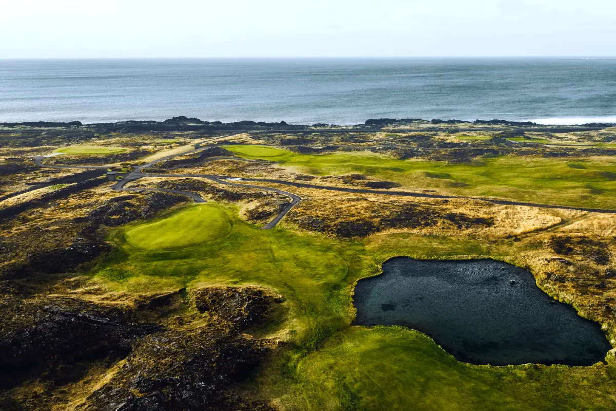 Aerial view of fairways winding through lava fields at Keilir Golf Club